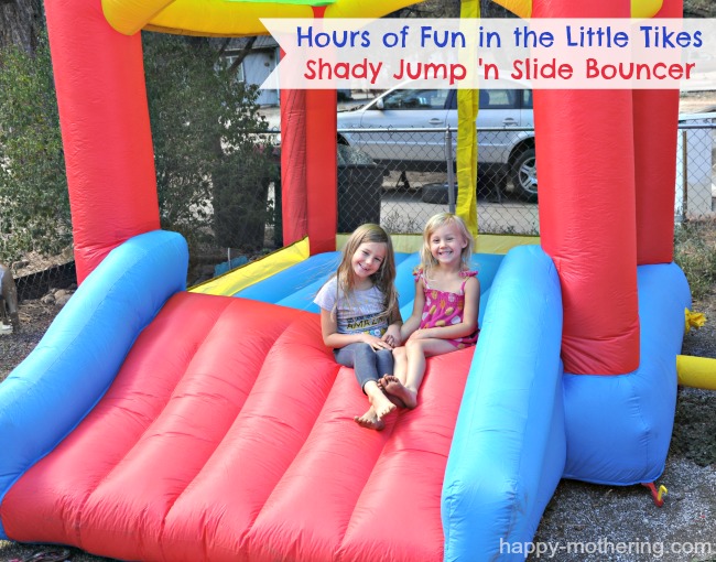 Zoë and Kaylee sitting in their bounce house