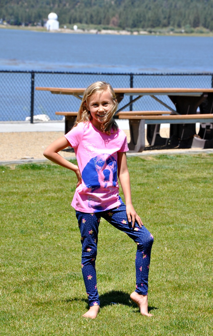 Kaylee posing on the grass at the park in her new outfit