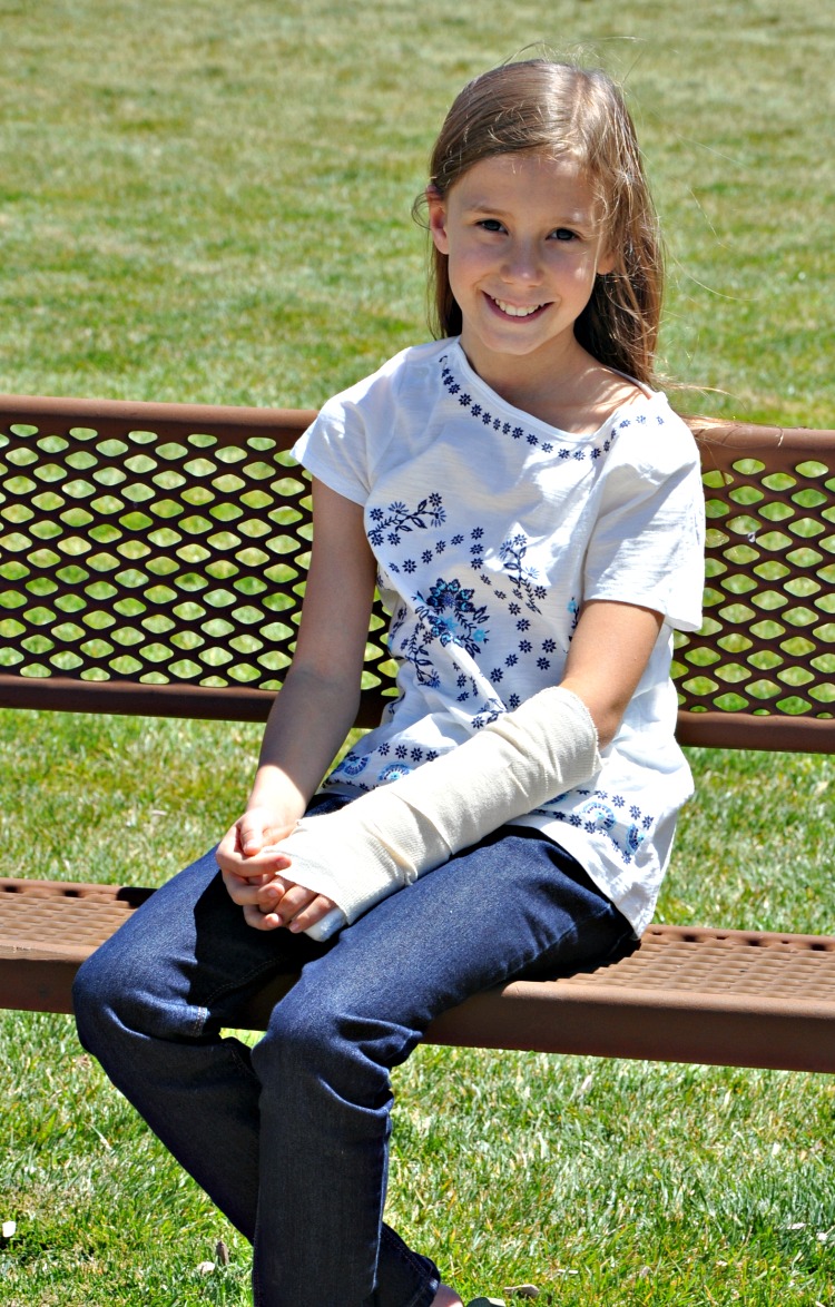 Zoë sitting on a bench at the park