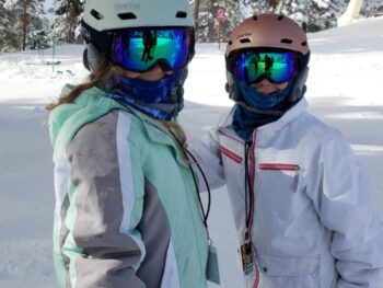 Zoë and Kaylee snowboarding in full gear