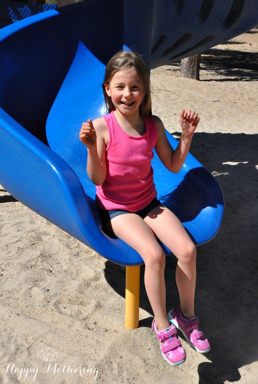 Zoë on the blue slide at the park