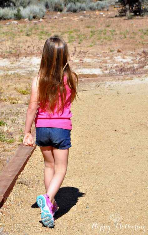 Zoë walking at the park on the dirt path