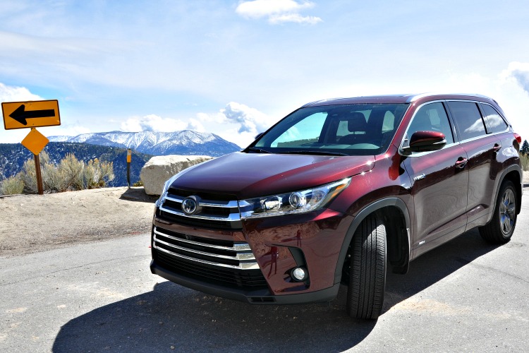 Toyota Highlander Hybrid in a mountain turnout with clouds and mountains behind it