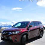 Toyota Hylander Hybrid with snowy mountains and blue skies in the background