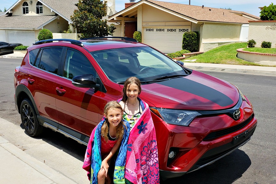 Zoë and Kaylee in front of the red Toyota RAV4 we reviewed