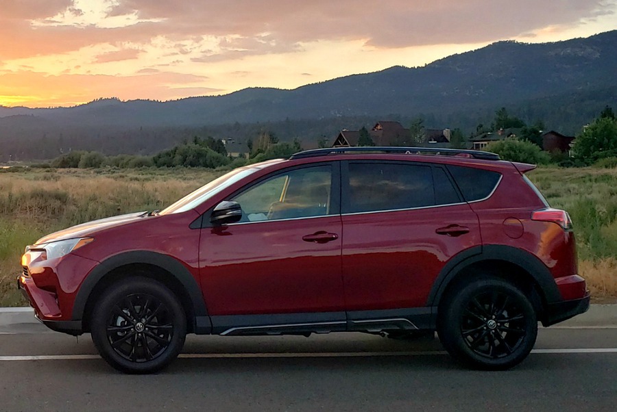 Side view of the Toyota RAV4 AWD Adventure at sunset - red and sporty